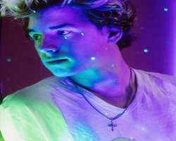 The star always wears a cross in his neck which gives hint about his religious faith.